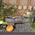 Rural Style Garden Ornament with Stone Structure Pumpkin Vegetables Green Plants Bamboo Background and Pebble Ground