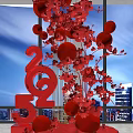 Floral Art Installation with Red Flowers Red Spheres 2025 Number Design and City Night View