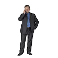 Businessman in Dark Suit and Blue Shirt Talking on Phone with Left Hand in Pocket Against Gray Background