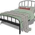 Double Bed With Black Metal Frame Curved Headboard Green Quilt And Leopard Print Blanket