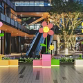 Vibrant Flower Shaped Art Installations With Colorful Block Planters In Mall Atrium