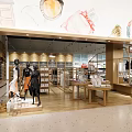 Stylish Shopping Mall Store Interior With Wooden Shelves Clothing Displays And Warm Lighting