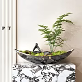 Bonsai Plant in Black Marble Bowl with Green Fern and Yoga Figurine on Marble Countertop