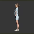 Woman In Light Blue Short Sleeve Top And Skirt With White Shoes On Gray Background