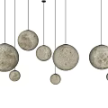 Cream Colored Moonlike Surface Spherical Pendant Lights with Multiple Sizes Hanging in Modern Design 3d model