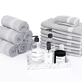 Gray Cotton Towels Rolled And Stacked With Marble Tray And Toiletries