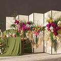Elegant Floral Arrangement With Green Folding Screen And Wicker Decorations On Green Tablecloth