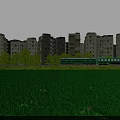 Peaceful Suburban Scenery With Green Field Old Buildings And Running Green Train Under Blue Sky