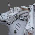 Aerial View of Snow Covered Building Complex with Tower and Parking Lot