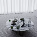 Circular Marble Table With Green Limes Vase Branches And White Curtain Background