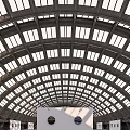 Modern Open Exhibition Hall with Arched Glass Roof White Walls and Displayed Artworks