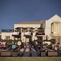Elegant Commercial Street With White Buildings Outdoor Seating Areas Umbrellas And Store Signs