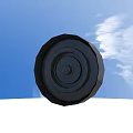 Black Tire Front View Against Blue Sky With White Clouds Outdoor Scene