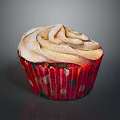 Delicious Fluffy Cupcake With Swirled Frosting And Red Polka Dot Wrapper