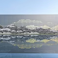 Landscape Feature Wall with Mountain Water Design and Reflection on Calm Water under Blue Sky