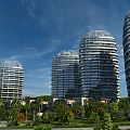 Modern Curved High Rise Hotel Buildings With Glass Facade Surrounded by Palm Trees And Greenery