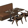 Brown Banquette Sofa With Tufted Design In Restaurant Setting With Table And Chairs