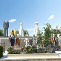 Mannequins in Various Outfits Displayed Outdoors With Green Plants Trees and Blue Sky