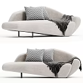 Curved Light Gray Sofa with Geometric Pattern Pillows Dark Throw Blanket and Black Metal Legs