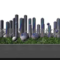 Modern Decorative Installation Featuring Tall Gradient Pillars Spherical Ornaments And Green Plants Base