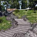 Natural Stone Stairs In Lush Garden With Green Trees Grass And Wooden Bench