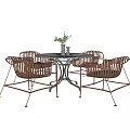 Stylish Round Table And Wicker Chairs Set With Metal Legs And Decorative Plant