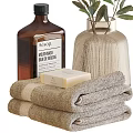 Stylish Bathroom Accessories With Towels Soaps Vase And Amber Bottles