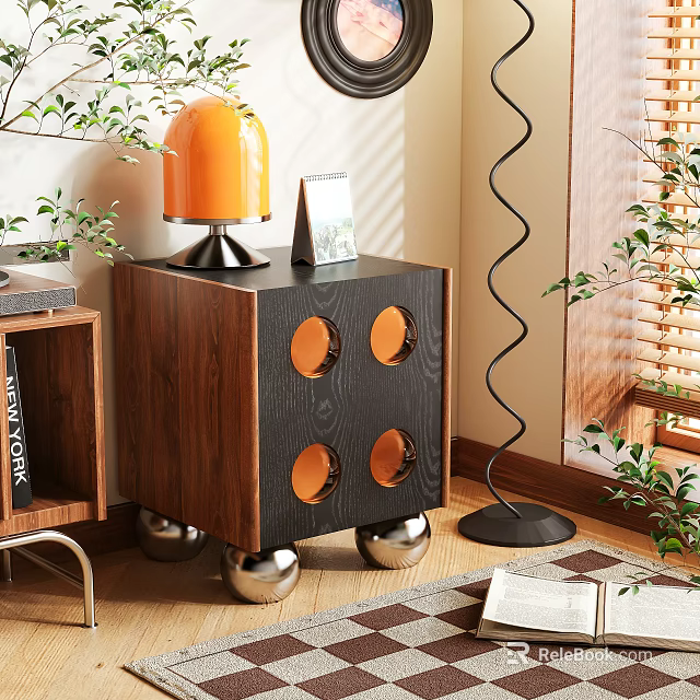Wooden Nightstand With Black Panel Orange Lamp Photo Frame Circular Cutouts And Silver Spherical Legs 3d model 