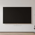 Large Black Wall Mounted Television On White Wall With Modern Sculpture And Wooden Floor