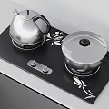 Modern Kitchen Utensils on Black Cooktop with Silver Teapot Covered Pot and Floral Patterns