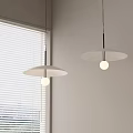 Two Modern White Pendant Lights With Round Shades Near Window Blinds And Bright Bulbs