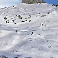 Skiing Scene On Snowy Mountain Slopes With Skiers And Clear Blue Sky
