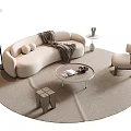Modern Curved Beige Sofa With Throw Blanket And Round Coffee Table In Minimalist Living Room
