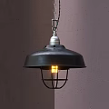 Industrial Black Pendant Light With Metal Cage Lit Bulb Hanging On Gray Wall