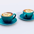 Teal cups with latte art holding coffee on saucers against light background