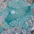 Aerial View Garden Landscape With Blue Pond Rocky Terrain And White Central Decorations