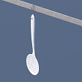 White Slotted Spoon Hanging On Metal Rod Against A Blue Background