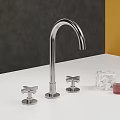 Sleek Modern Chrome Faucet with Cross Handles on White Countertop and Dark Gray Wall