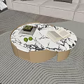 Modern Round Coffee Table With Marble Top Beige Base Green Plant Limes And Open Book