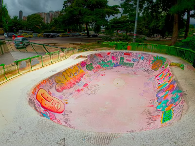 Colorful Graffiti Skate Bowl Area With Green Railings Trees And Parking Lot 3d model
