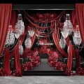 Wedding Floral Display With Red Curtains Crystal Chandeliers And Pink Red Flowers On Black Stage