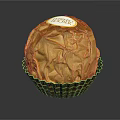 Delicious Chocolate In Golden Foil Wrapping With Label On Brown Wavy Paper Cup