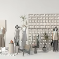 Chic Fashion Display Setup With Mannequins Apparel Plants And Decorative Grid Wall