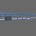 Spacious Industrial Warehouse With High Metal Roof Large Glass Windows Supporting Columns And Concrete Floor