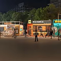 Night Outdoor Colorful Food Stalls with People Gathering Near Trees and Buildings