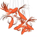 Red Fish Shaped Chandelier with Artistic Design Hanging in Modern Interior
