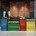 Colorful Garden Decor Planters With Green Plants And Flowers In Indoor Café