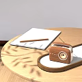 Wooden Radio Speaker on Wooden Table with Notebook Pencil and White Cup