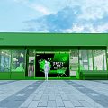 Green Lighting Accessories Showroom Exterior With Glass Windows And Display Items