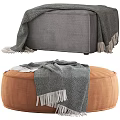Round Gray and Square Brown Ottomans with Fringed Blankets on Top